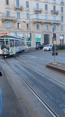 Milan street scenes captured including tram, landmarks, art installation
