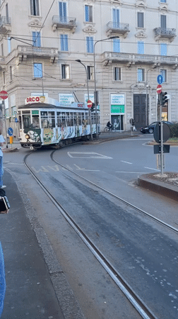 Milan street scenes captured including tram, landmarks, art installation