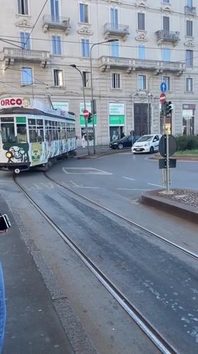 Milan street scenes captured including tram, landmarks, art installation