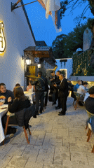 Musicians serenade diners at outdoor Belgrade restaurant