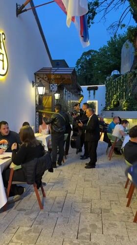 Musicians serenade diners at outdoor Belgrade restaurant