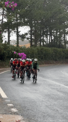 Cycling group rides through Da Lat's wet streets past ornate buildings