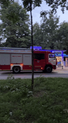 Fire trucks and heavy equipment moving through Moscow streets at dusk