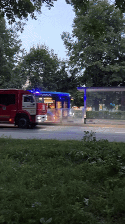 Fire trucks and heavy equipment moving through Moscow streets at dusk