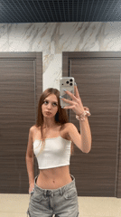 Mirror selfies in a bathroom, white top and denim shorts.