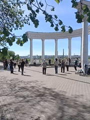 Morning exercise class held near river with city skyline
