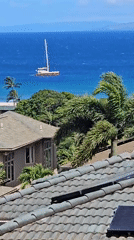 Sailboat spotted from Napili rooftop, white hull and red deck