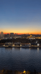 Moscow River skyline glows at dusk under a crescent moon