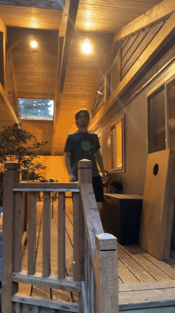 Late-night campfire hangout at a cabin deck in Ashford