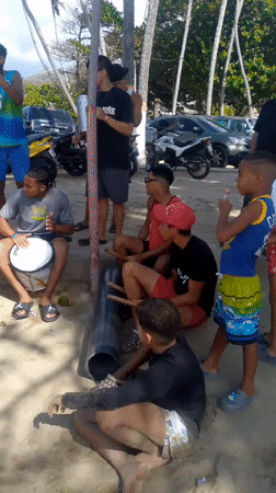 Lively beach day in Naiguatá with drumming, swimming, and vendors