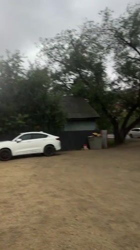 Gravel lot, locked door, and a wooden house in Blagoveshchensk