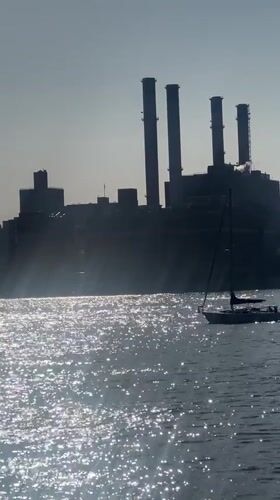 Sailboat spotted on NYC waters near industrial waterfront
