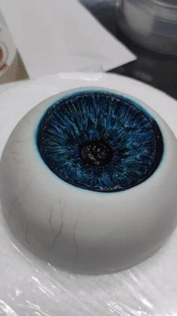 Hyper-realistic edible eyeball being painted and detailed in Ankara