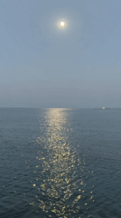 Full moon rises over Issyk-Kul Lake at dusk, Bosteri