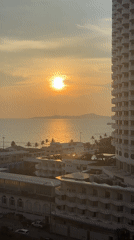 Sunset cityscape captured over water in Pattaya, Thailand
