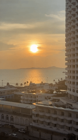 Sunset cityscape captured over water in Pattaya, Thailand