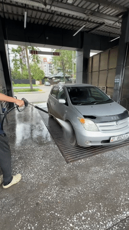 Man washes car at Bishkek facility early morning