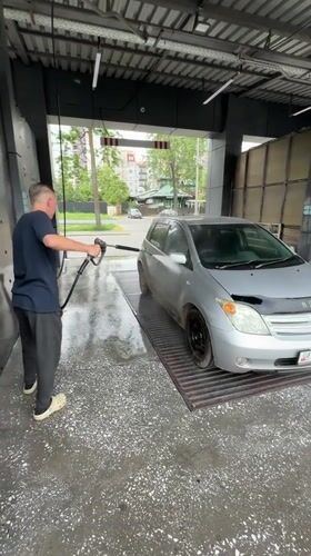 Man washes car at Bishkek facility early morning