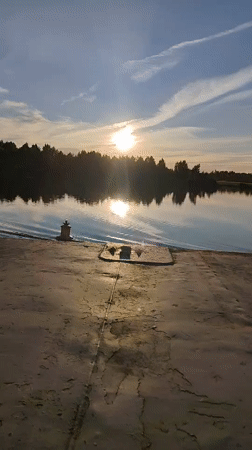 Sunset barge ride on a Russian river, passing under a railway bridge