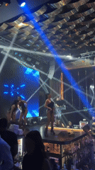 Nightclub celebration with stage performers captured by witnesses