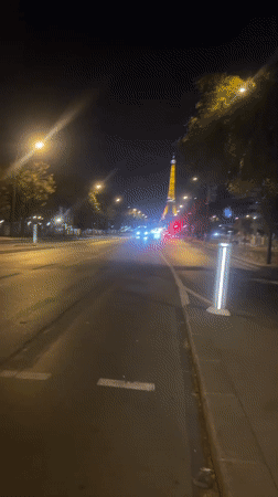 Eiffel Tower glowing gold on a summer night in Paris