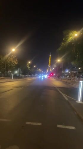 Eiffel Tower glowing gold on a summer night in Paris