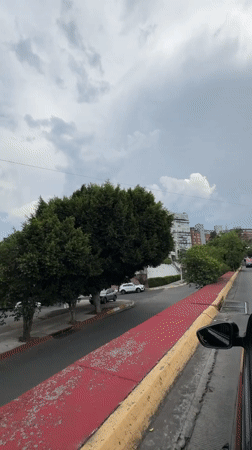 Vehicle captures uphill Mexico City street with distinctive curbing