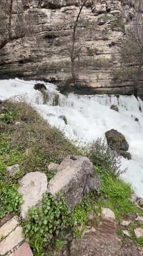 Waterfall flows over rocks near Bulgarian towns