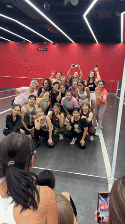 Dance group poses for photo in Thai studio