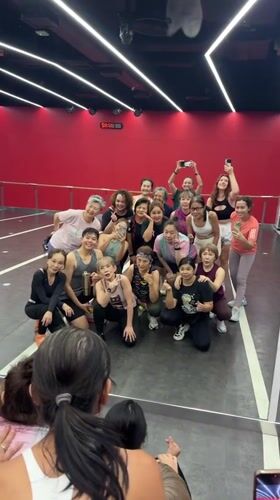 Dance group poses for photo in Thai studio
