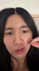 Woman photographed making expressions in Paris bedroom