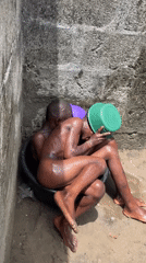 Children bathe outdoors in plastic basins in Badagry, Nigeria