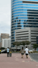 Man takes phone call on Dubai street near office building