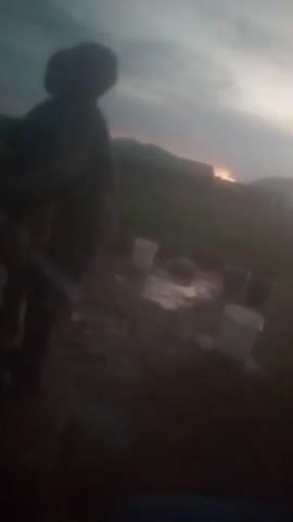 This media file, filmed in Balewa, Nigeria, captures a dimly lit outdoor scene at what appears to be dusk or dawn, indicated by the soft, diffused light and the colors of the sky. The footage is highly grainy and lacks clear focus, making specific details difficult to discern.

The primary subjects are people, mostly seen as silhouettes or blurred figures. In the foreground of the first clip, a person in dark clothing, possibly wearing a helmet or hat, is visible, holding what might be a tool or equipment. Surrounding them are several buckets, some white and some appearing darker, placed on the ground, with some containing water. The ground itself is damp and muddy. In the background, the landscape features rolling hills and what looks like a distant settlement with a light glow, suggesting artificial illumination or perhaps the last rays of the sun.

Subsequent clips show more groups of people, also indistinct. There are hints of clothing colors like white, blue, and red. In one segment, an orange container is visible, possibly a large jerrycan. The setting appears to be a somewhat rural or undeveloped area, with simple structures visible in the distance in one of the later frames, featuring reddish-brown roofs and light-colored walls, resembling small buildings or homes.

The overall impression is one of an outdoor gathering or activity taking place during a transitional period of the day. The low light and lack of clear focus contribute to a somewhat mysterious or somber atmosphere, though it's impossible to ascertain any specific emotions from the blurred figures. There is no visible text in the media file. The presence of buckets suggests activities related to water collection or distribution, which is common in many parts of Nigeria, especially during certain times of the day or in areas where water access may be challenging.