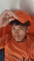 Young man in orange cap filmed at Venezuelan beach