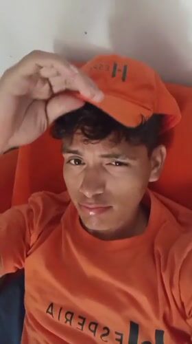 Young man in orange cap filmed at Venezuelan beach