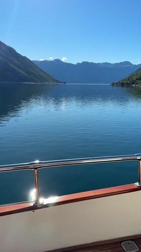 Sailboat cruises calm Montenegro waters on sunny morning