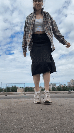 Woman photographs herself near docked ships in Shushary waterfront