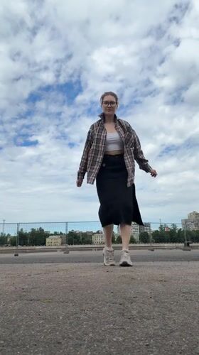 Woman photographs herself near docked ships in Shushary waterfront
