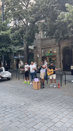 Live street music on Prague's cobblestones, guitar and voices