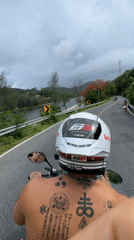 Couple rides motorcycle through Rawai Thailand early morning