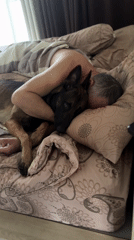 Man sleeps cuddling dog in Thailand bedroom