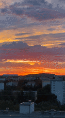 Dramatic sunset colors streak the sky over Munich
