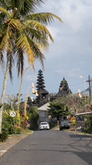 Balinese village road lined with traditional meru temple and ceremonial decor