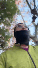 Masked individual in green jacket spotted on Los Angeles sidewalk