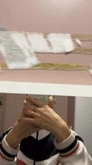 Person takes mirror selfie while removing wall object in Abakan