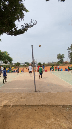 Youth sports gathering in green tracksuits at Nigerian facility