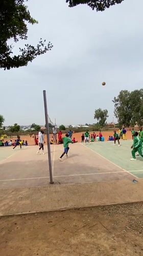 Youth sports gathering in green tracksuits at Nigerian facility