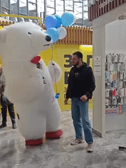 Polar bear mascot meets woman with French bulldog in Novosibirsk mall