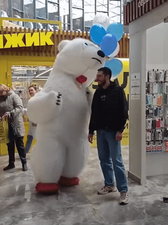Polar bear mascot meets woman with French bulldog in Novosibirsk mall